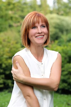 Portrait of an attractive woman who is posing at a park