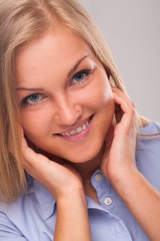 Closeup portrait of young blond caucasian woman smiling