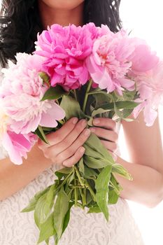 Beautiful bouquet of rose peonies in woman's hands