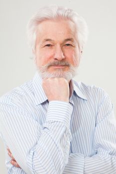 Handsome elderly man with beard isolated over white background