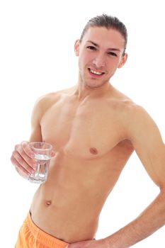Portrait of a handsome shirtless man who is drinking water over a white background