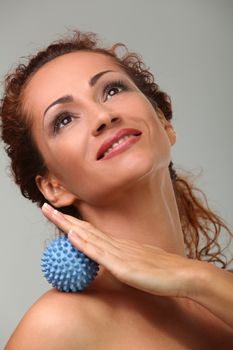 Beautiful middleaged caucasian woman massages herself