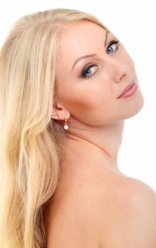 Portrait of a beautiful girl with blonde hair and naked shoulders who is posing over a white background