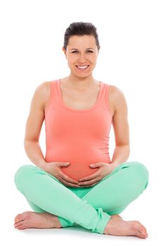 Beautiful pregnant woman sitting; isolated over white background