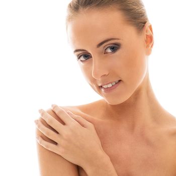 Portrait of a beautiful girl with naked shoulders who is posing over a white background