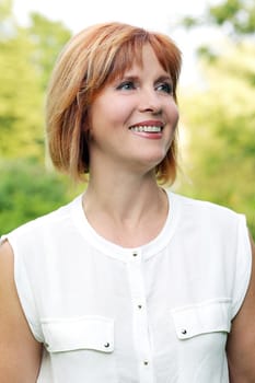 Portrait of an attractive woman who is posing at a park