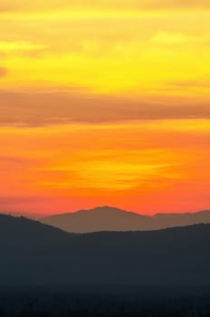 Beautiful orange and red sky over mountain range after sunset