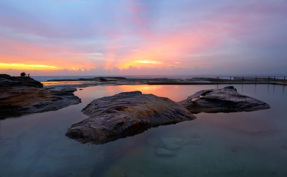 North Curl Curl rock pool is built into the northern Dee Why headland and includes a large rock, nevertheless people still swim laps here in the morning.