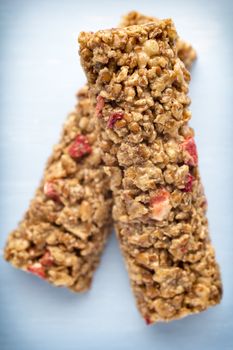 Muesli bars, cereal bars on the wooden background.