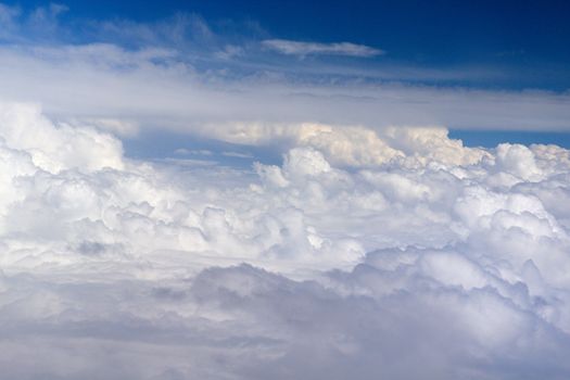 Photo shows details of white clouds and blue sky.