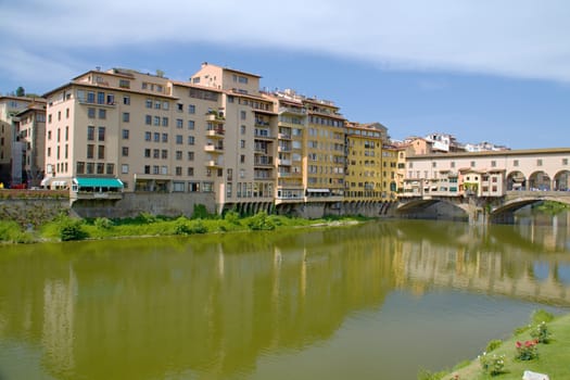 Photo shows a general view onto the city river bank with its houses.