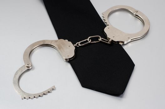 black tie and handcuffs