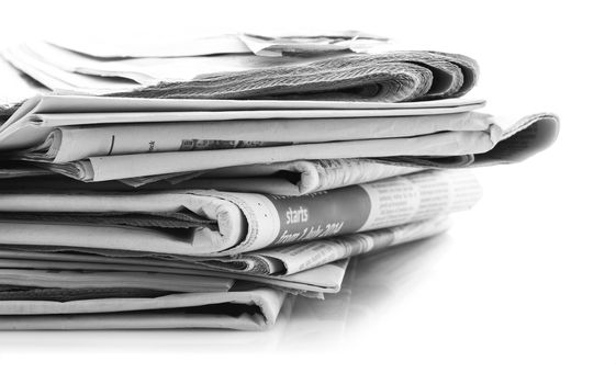 Various newspapers over white background 