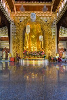 PENANG, MALAYSIA - MARCH 10, 2015: Large Gold Buddha Statue in Dhammikarama Burmese Buddhist Temple hall entrance. This is a popular tourist attraction for locals and tourists visiting Penang.