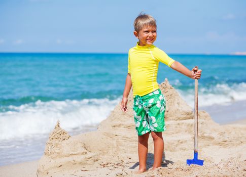 Young boy playing in the sand on the beach