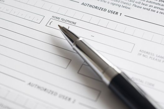Blank credit application form and pen close up 