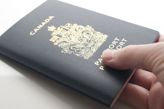  A hand holding a Canadian Passports