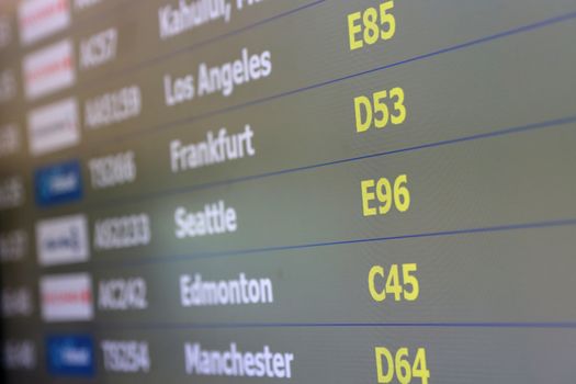 Macro airport departures monitor showing flight gate