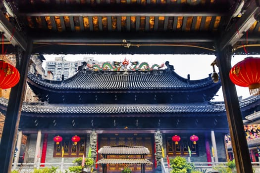 Entrance Tianwang Hall Gate Red Lanterns Temple of Six Banyan Tree Buddhist Temple Guangzhou City Guangdong Province China.  Temple built in 537, given its name in the Song Dynasty Red Lanterns Say luck on them.