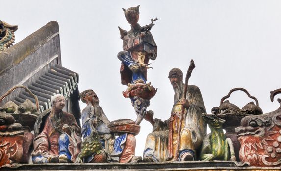 Ceramic Figures Statues Dragons Chen Ancestral Taoist Temple Guangzhou City Guangdong Province China.  Most famous Taoist Ancestral temple in Guangzhou City, Guangdong Province, China.  Temple built in the Qing Dynasty in 1894.  Now known as Museum of Folk Arts and Crafts.