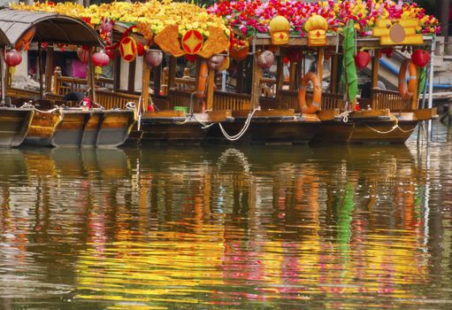 Flower Boats Reflection Lychee Bay Luwan Guangzhou Guangdong Province China.  Lychee Bay was founded in 209 in the Han Dynasty.  Canals have become a famous Guangzhou city park. 