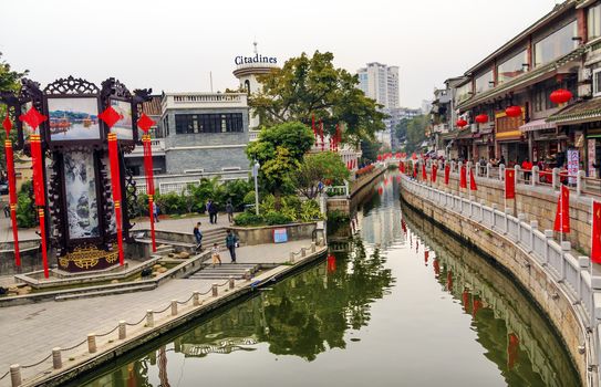 Canal Bridge Walking Street Lychee Bay Tourist Shops Luwan Guangzhou Guangdong Province China.  Lychee Bay was founded in 209 in the Han Dynasty.  Canals have become a famous Guangzhou city park.