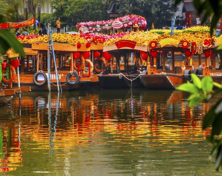 Flower Boats Reflection Lychee Bay Luwan Guangzhou Guangdong Province China.  Lychee Bay was founded in 209 in the Han Dynasty.  Canals have become a famous Guangzhou city park. 