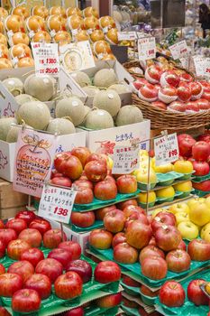 Osaka, Japan - October 26, 2014: Fresh fruits in a greengrocery in Kuromon Market in Osaka, Japan. The Kuromon Market has been called 'Osaka's Kitchen' since it opened as many cooks in Osaka come here to get the ingredients.