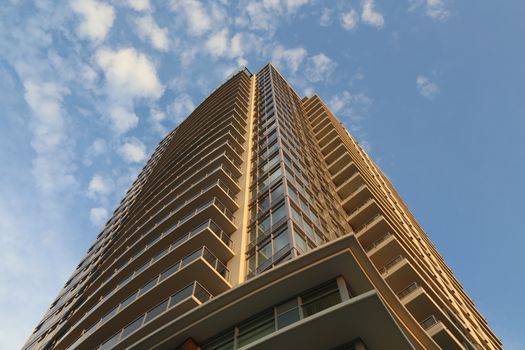 Coquitlam, BC Canada - August 24,  2014 : Brend new high rise building against blue sky in Coquitlam BC Canada.