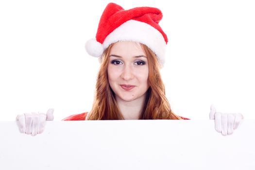 Young woman in Mrs Santa Claus hat holding a blank sign. Isolated on white. Extra white space with your message can be added to the bottom of the picture.