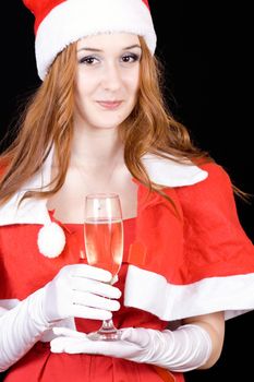 Woman in the red hat with the glass of champagne on black background