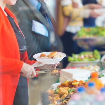 Banquet lunch break at conference meeting. Assortment of food and beverage.