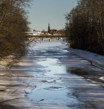 Thawing River with Distant Church in Umea, Sweden