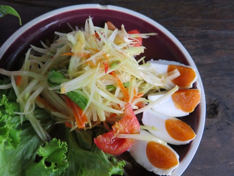 closed up papaya salad with salted egg