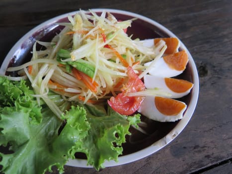 closed up papaya salad with salted egg