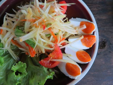 closed up papaya salad with salted egg