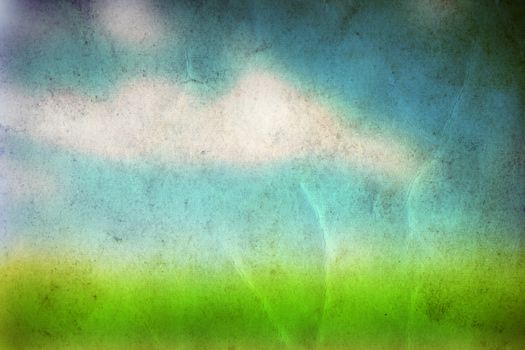 Conceptual green summer grass and blye sky on old paper vintage background