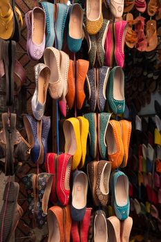 Colourful leather shoes on display in a bazaar in the Medina of Marrakech, Morocco.