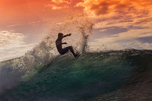 Surfer on Amazing Wave at sunset time, Bali island.