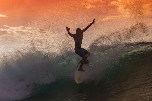 Surfer on Amazing Wave at sunset time, Bali island.