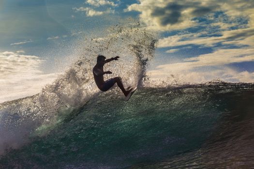 Surfer on Amazing Wave at sunset time, Bali island.