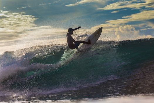 Surfer on Amazing Wave at sunset time, Bali island.