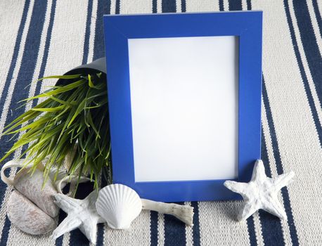 Beautiful vintage collage with photo frame on an old rug, with sea shells and starfish.