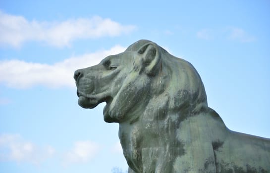 Sculpture of a lion with clouds