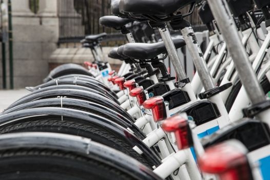 Several urban rental bikes parked