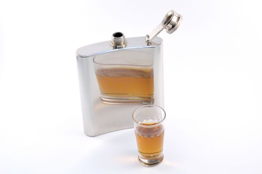Metal flask and whiskey glass isolated