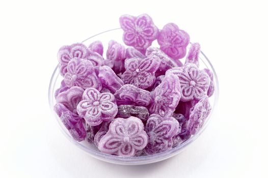Violet candies on white background