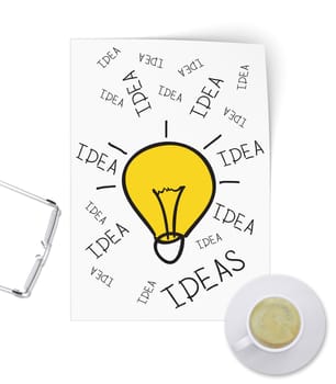 Illuminating idea in form of sketch paper. Full cup of coffee is on table. Isolated on white background
