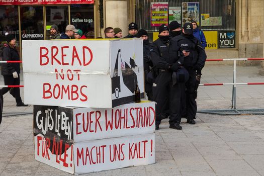 Munich, Germany - February 7, 2015: Police cordon and signs banners on protest rally anti-NATO peaceful demonstration in the center of Europe