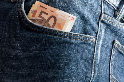 euro money in the front pocket of jeans